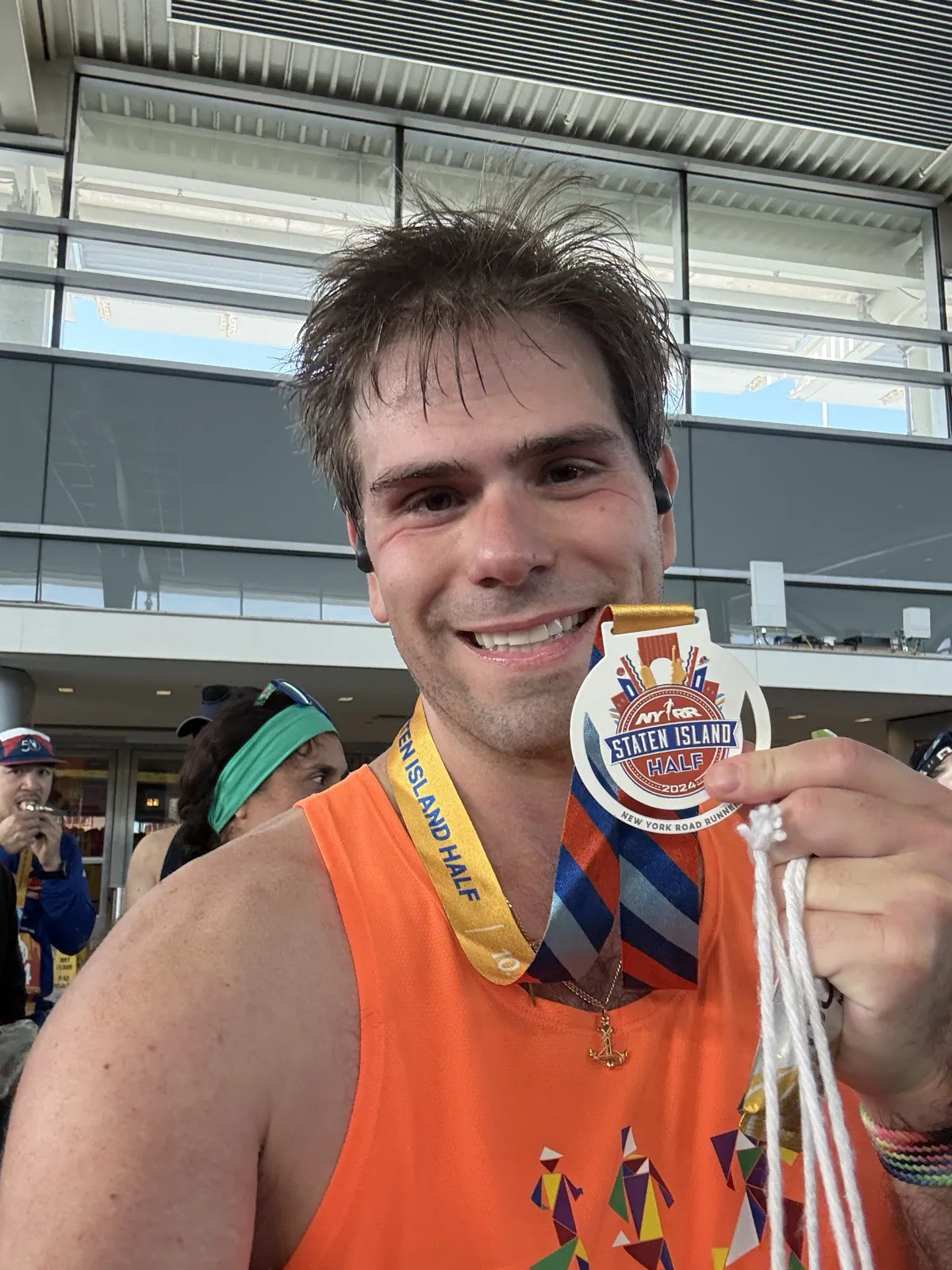 Nick holding up a Staten Island Half medal