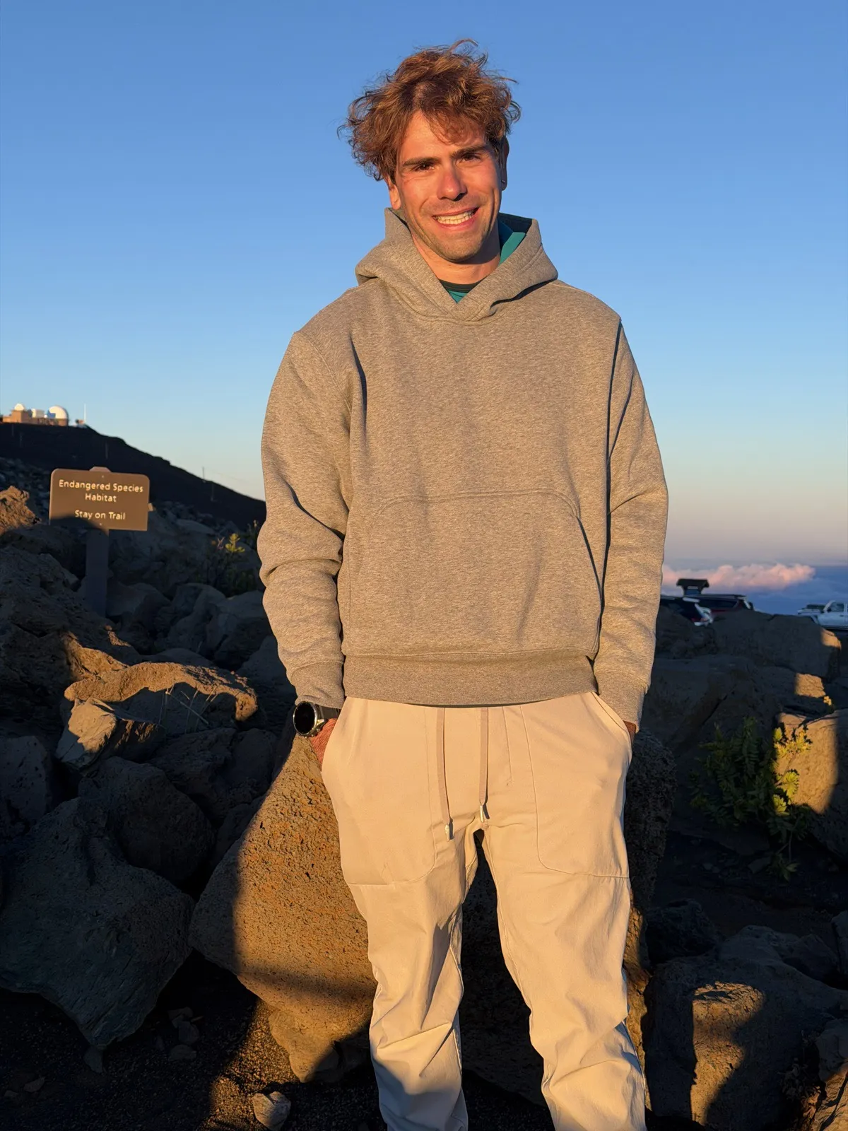 Nick at a mountain summit at golden hour